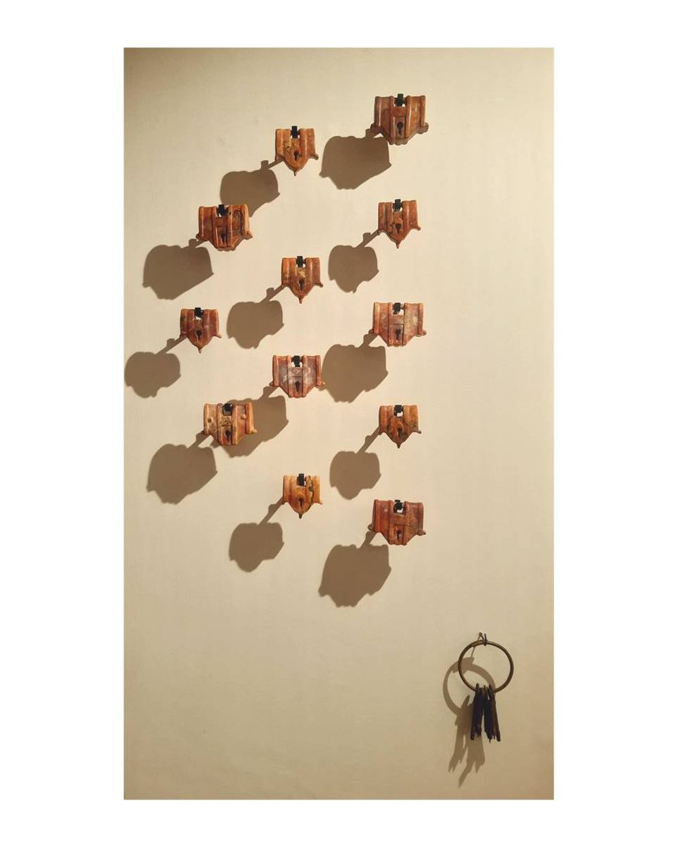 Locked vulnerabilities, Semi Circle of 12 hanging locks with a bunch of 7 keys